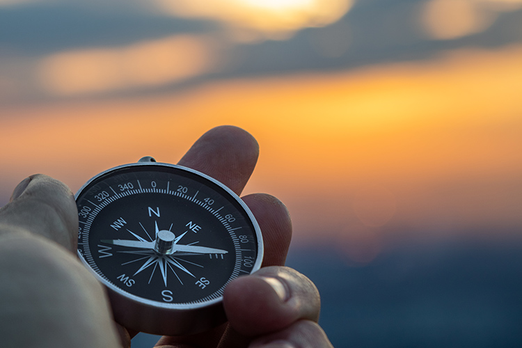 man holding compass